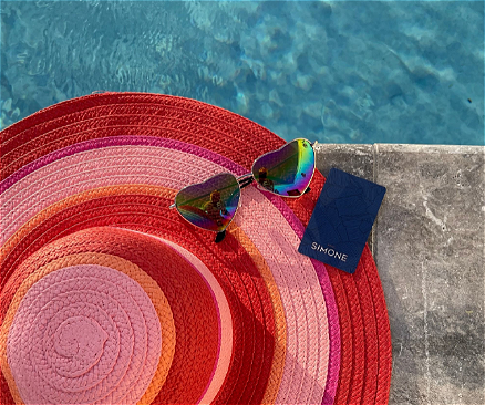 Red hat with sunglasses by pool loading=